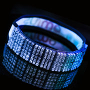 Viseira branca Orca Sports com detalhes brilhantes, refletida em fundo escuro.